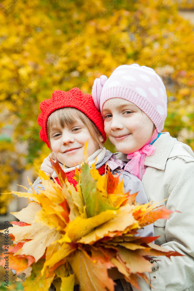 Portrait of two girls  in   autumn