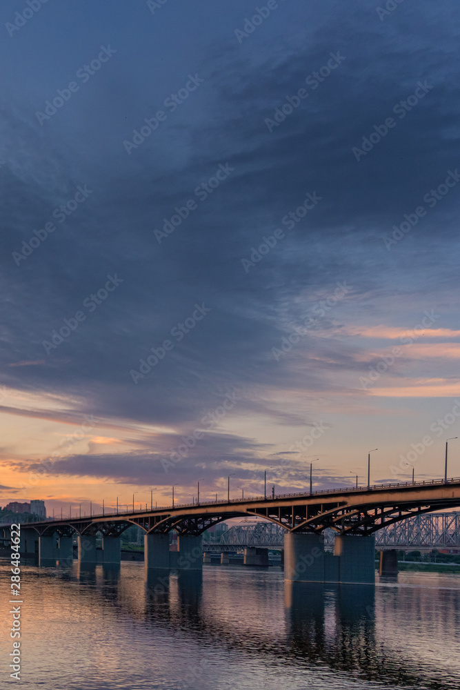 Bridge over the Yenisei river evening sunset. Krasnoyarsk, Russia. vertical