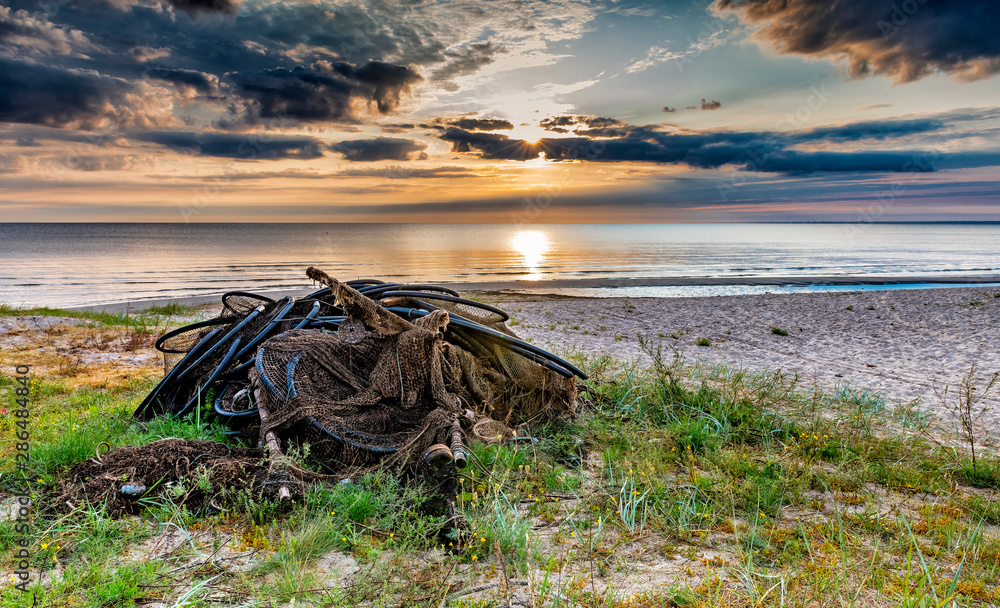 Fishing net on a sandy beach of the Baltic Sea near a village of fishermen