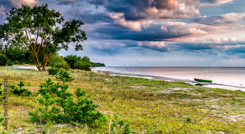 Coastal landscape with small fishing boat at sandy beach of the Baltic Sea