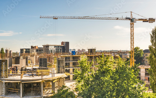 View of the construction of a high-rise apartment building in the center of Kiev, Ukraine. With the help of tower cranes, concrete work is carried out on the fifth floor.