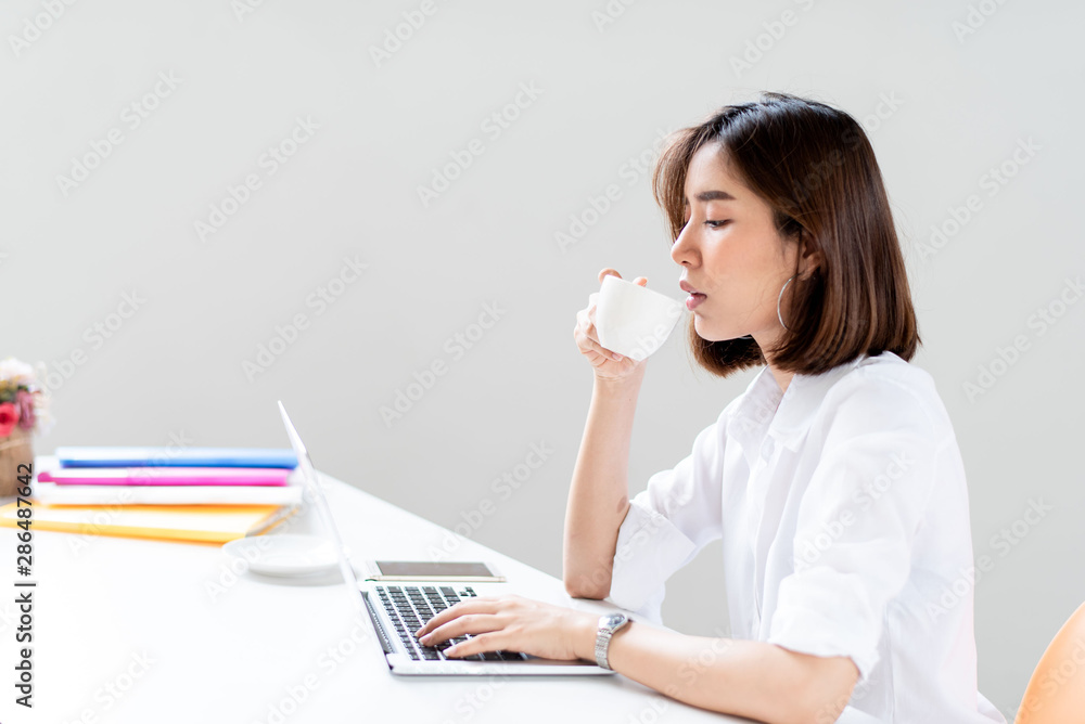 Young woman drink coffee in an office Young woman drink coffee in an office