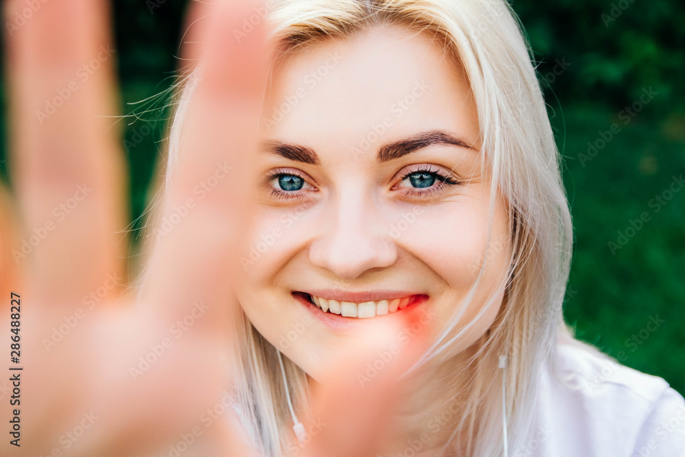 Portrait of beautiful blonde girl smiling making frame with hands and fingers with happy face. Creativity and photography concept Portrait of beautiful blonde girl smiling making frame with hands and fingers with happy face. Creativity and photography concept