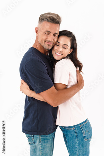 Cheerful happy adult loving couple isolated over white wall background.