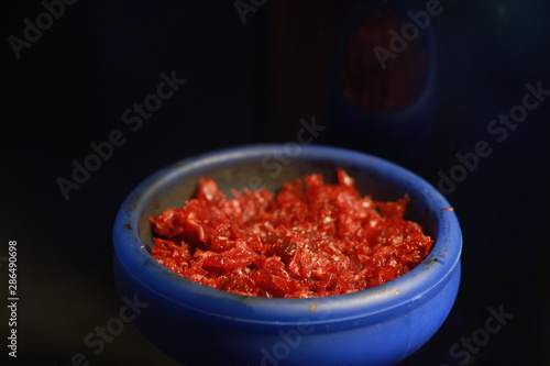 bowl with tobacco for hookah. berries on a black background