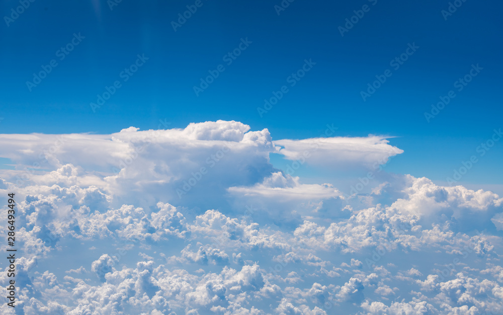 Naklejka premium The blue sky and white clouds at an altitude of 10,000 meters under the sun