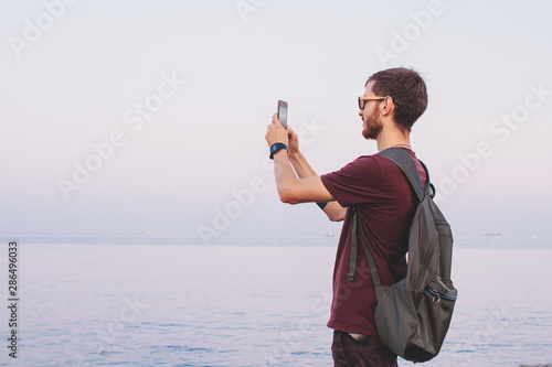 Young man take a picture by his smart phone