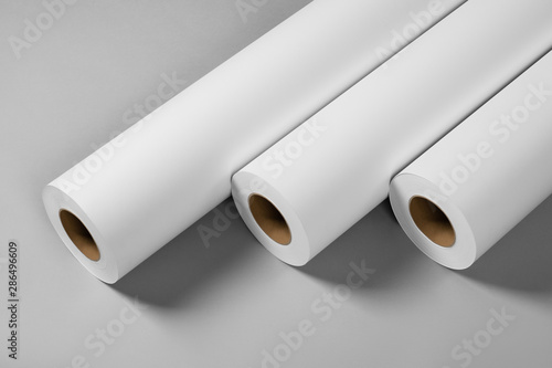 Blank white paper rolls isolated on gray background. Mockup paper for magazines, catalogs or newspapers isolated on gray backdrop, Printing house theme or wrapping paper for presents