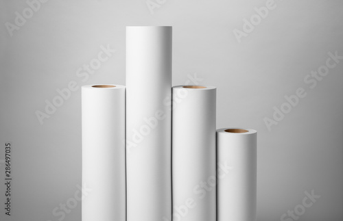 Blank white paper rolls isolated on gray background. Mockup paper for magazines, catalogs or newspapers isolated on gray backdrop, Printing house theme or wrapping paper for presents