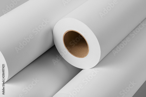 Blank white paper rolls isolated on gray background. Mockup paper for magazines, catalogs or newspapers isolated on gray backdrop, Printing house theme or wrapping paper for presents