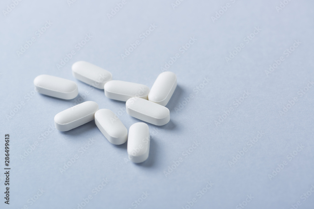 Lysine tablets. Concept for a healthy dietary supplementation. Nervous System Support. Bright background. Close up. Copy space. Lysine tablets. Concept for a healthy dietary supplementation. Nervous System Support. Bright background. Close up. Copy space.