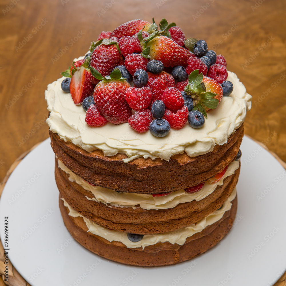 Three tiered birthday cake with fruit toppings. Three tiered birthday cake with fruit toppings.