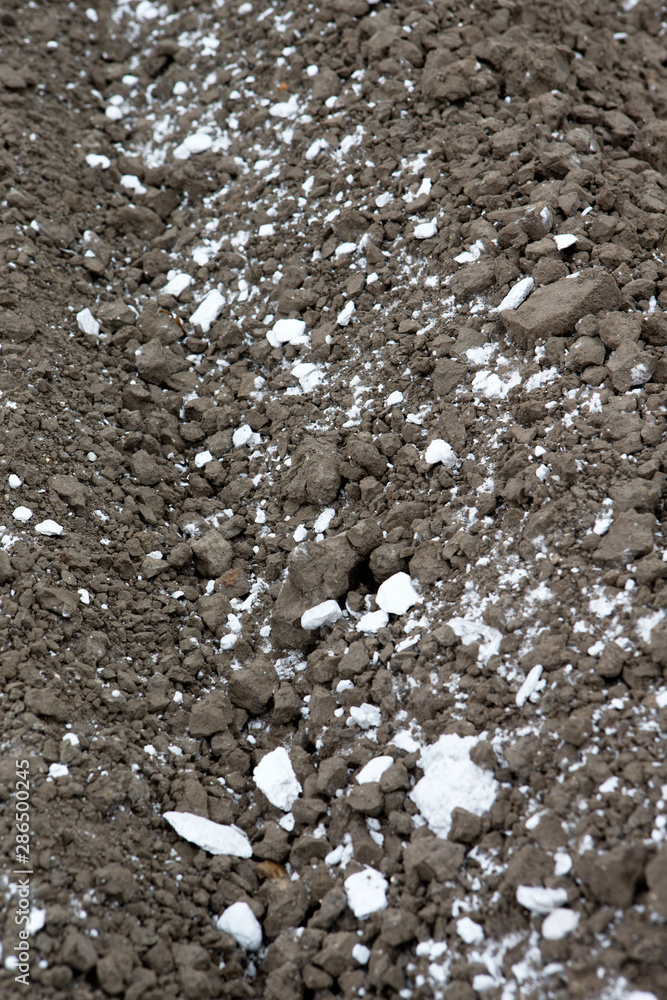 Fertilizing soil with chalk. Fields with fertilizer Fertilizing soil with chalk. Fields with fertilizer