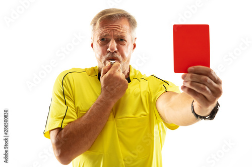 Referee showing a red card and gesturing to a football or soccer player while gaming isolated on white studio background. Concept of sport, rules violation, controversial issues, obstacles overcoming.