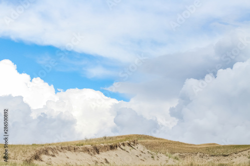 Wild sand dunes in Nida, Lithuania. Landscape before the storm, sand and wind, dark sky.