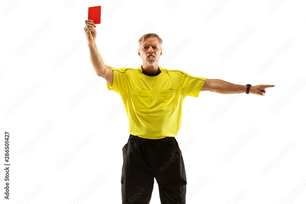Fototapeta premium Referee showing a red card and gesturing to a football or soccer player while gaming isolated on white studio background. Concept of sport, rules violation, controversial issues, obstacles overcoming.