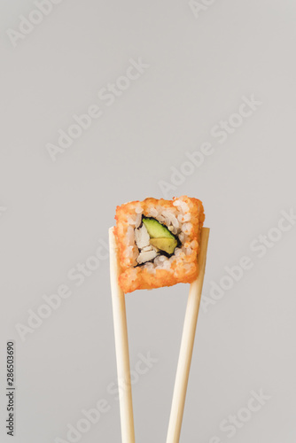 Chopsticks with sushi roll
