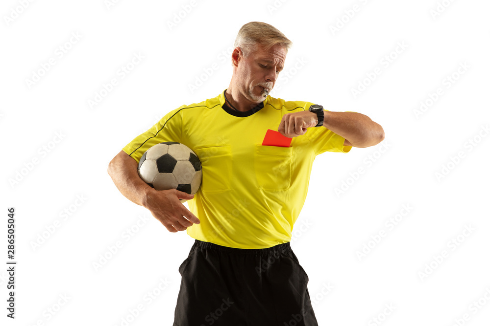Referee holding ball and showing a red card to a football or soccer player while gaming on white studio background. Concept of sport, rules violation, controversial issues, obstacles overcoming.