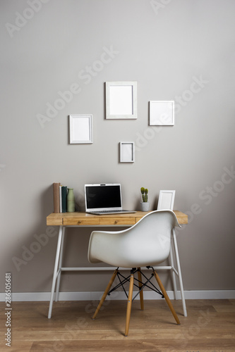Desk concept with white chair and laptop