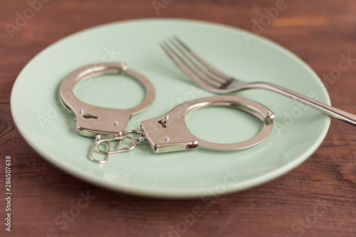 a pair of metal handcuffs on a plate
