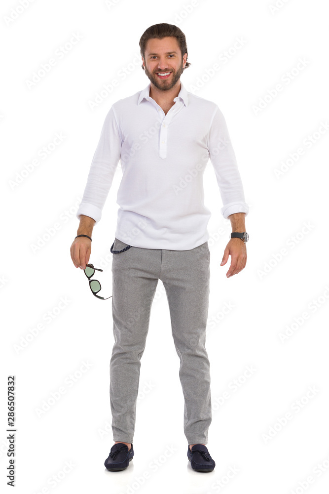 Smiling Elegant Man Is Standing And Holding Sunglasses. Smiling Elegant Man Is Standing And Holding Sunglasses.