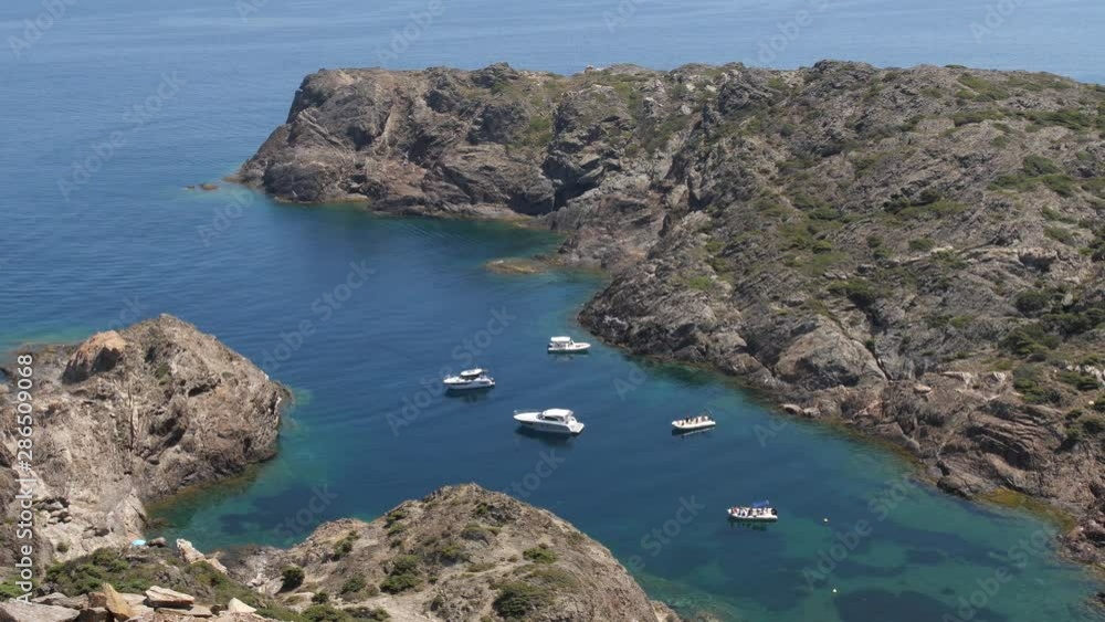 Rocks in the ocean, a bay with yachts. The water is calm and turquoise. 4K Slow Mo Rocks in the ocean, a bay with yachts. The water is calm and turquoise. 4K Slow Mo