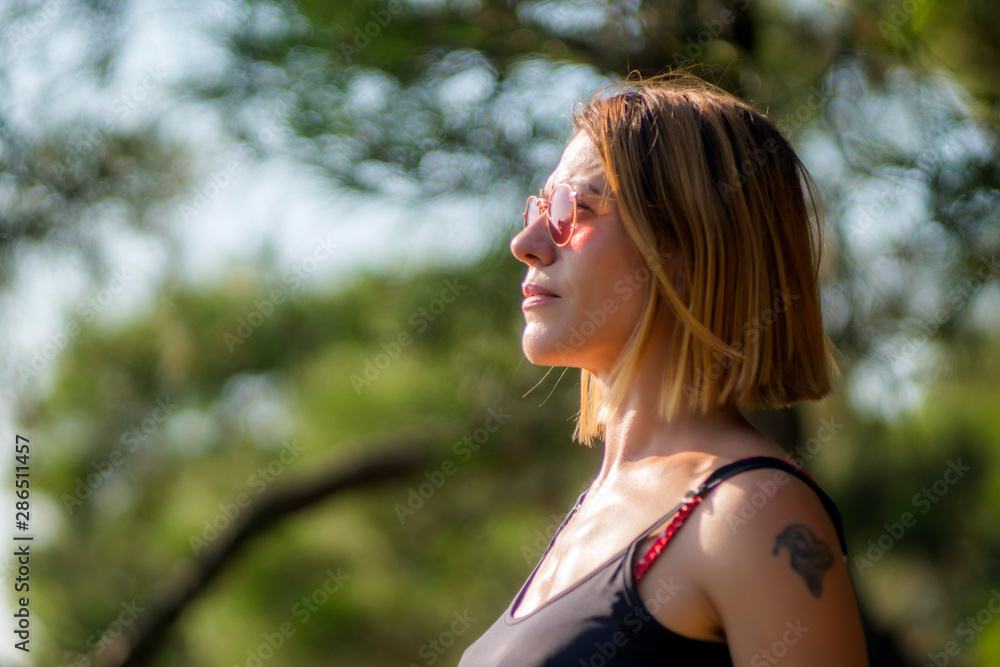 Mid aged happy woman is practising yoga in forest. Mid aged happy woman is practising yoga in forest.