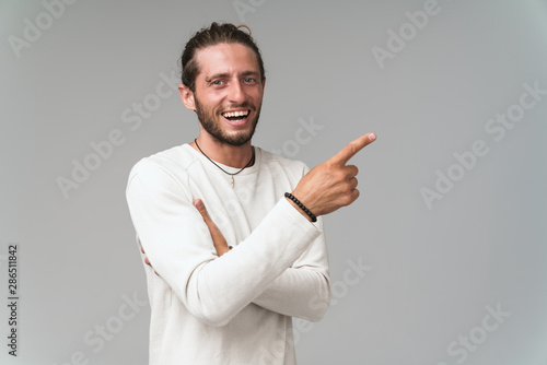 Happy young guy wearing casual clothing standing