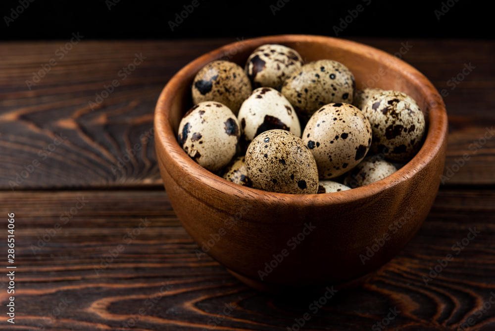 Quail eggs on dark wooden background. Quail eggs on dark wooden background.