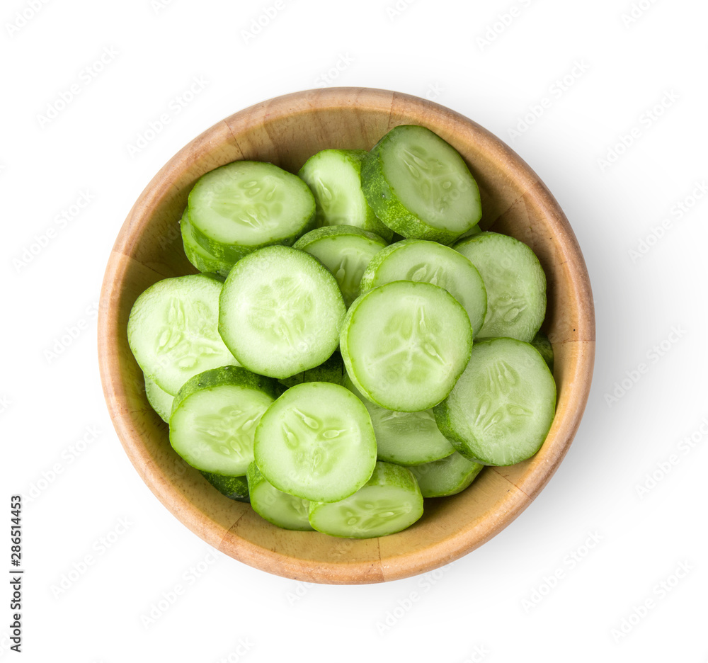.Fresh cucumber slices in wood bowl isolated on white background. top view .Fresh cucumber slices in wood bowl isolated on white background. top view