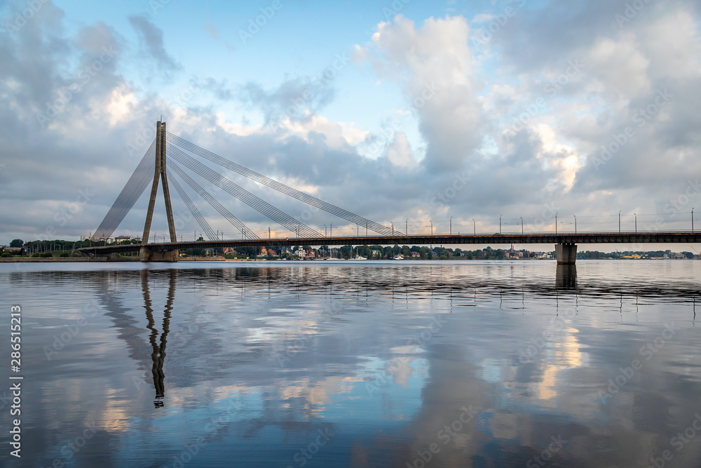 Panoramic view of the Old Town from the cable-stayed bridge to the Daugava embankment at sunset. Riga, Latvia. general view on Riga embankment and river ships.