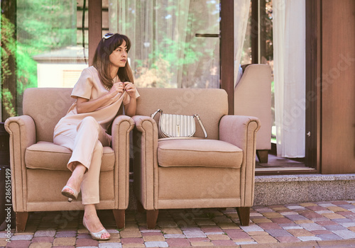 woman on a sofa near a restaurant photo