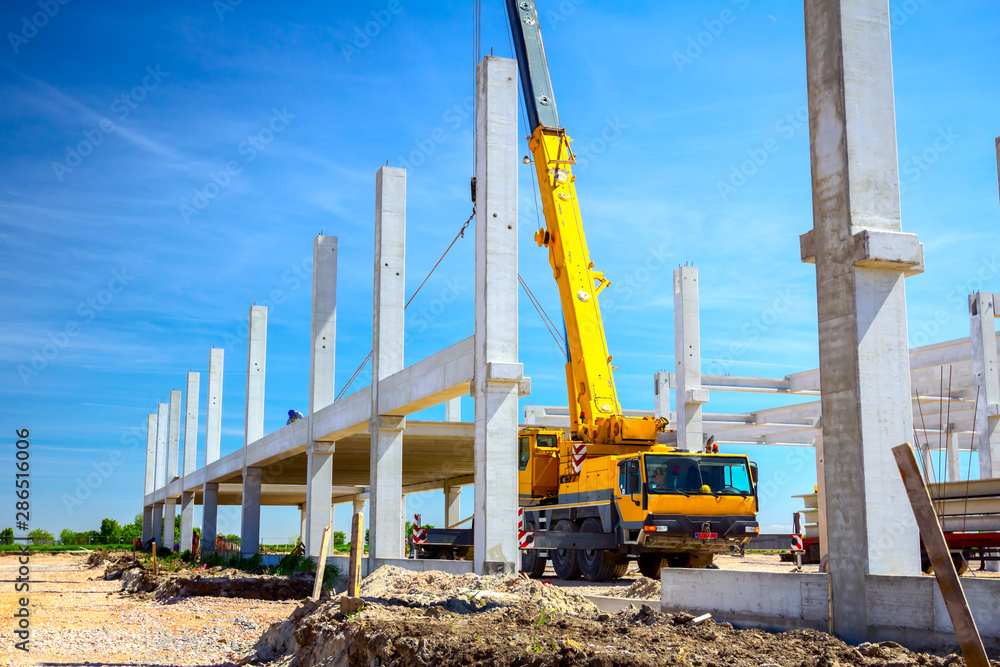 Mobile crane is carry concrete joist to assembly huge hall Mobile crane is carry concrete joist to assembly huge hall