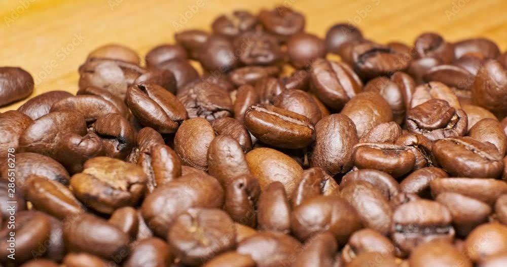 Coffee beans close up isolated sliding movement Coffee beans close up isolated sliding movement