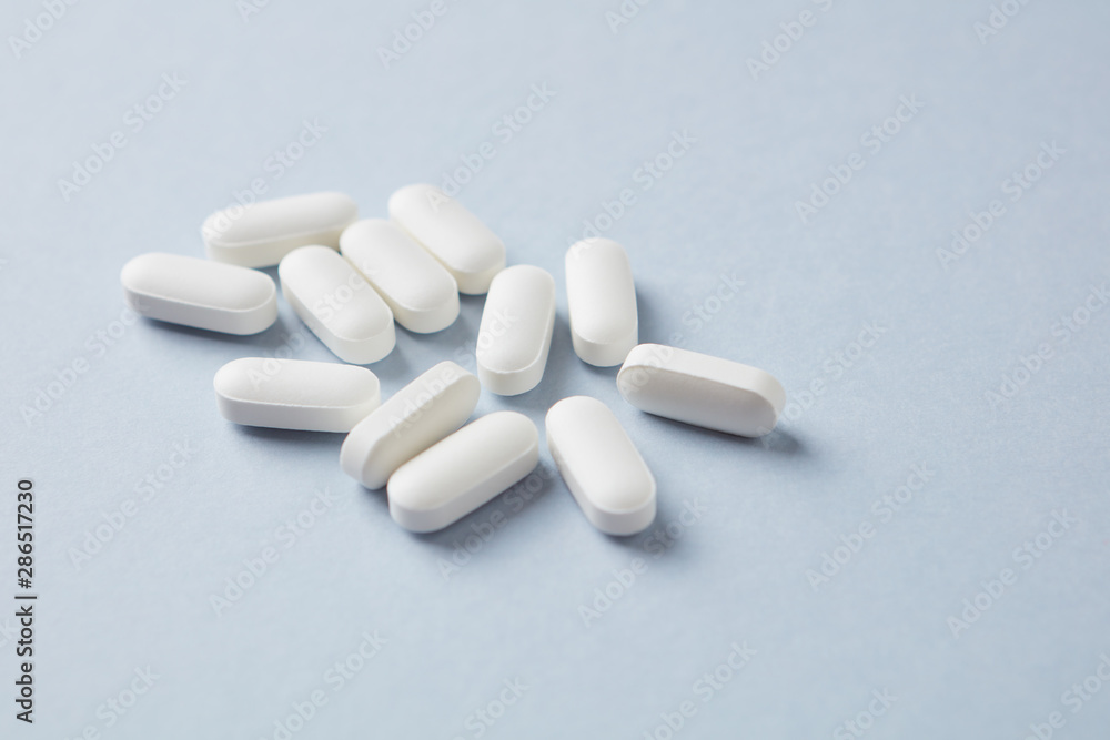 Lysine tablets. Concept for a healthy dietary supplementation. Nervous System Support. Bright background. Close up. Copy space. Lysine tablets. Concept for a healthy dietary supplementation. Nervous System Support. Bright background. Close up. Copy space.