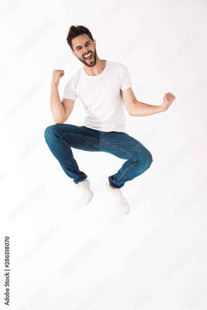 Full length of a cheerful young brunette bearded man