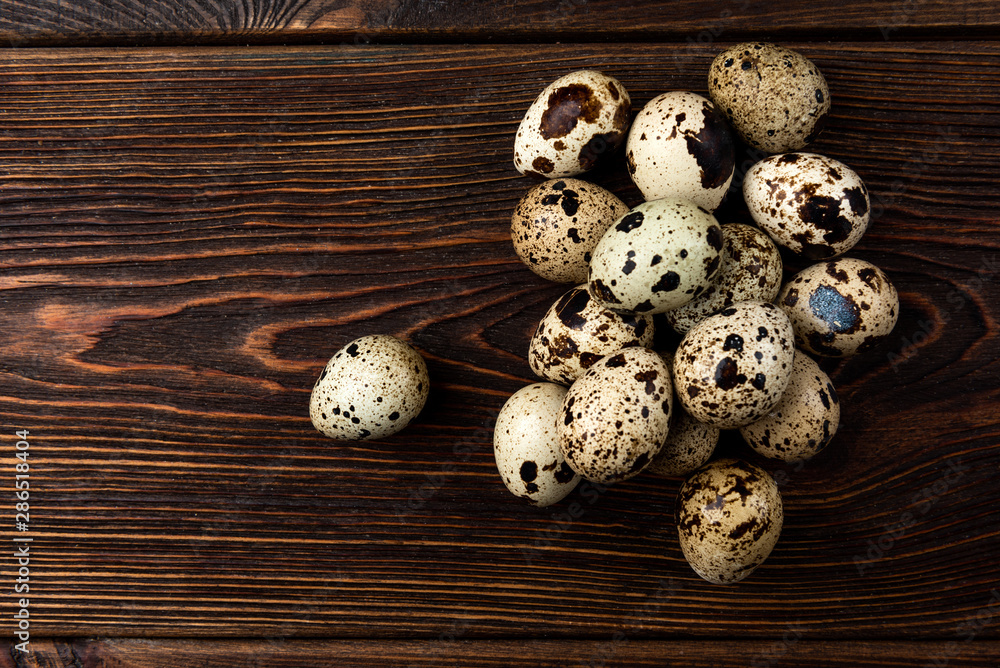 Quail eggs on dark wooden background. Quail eggs on dark wooden background.