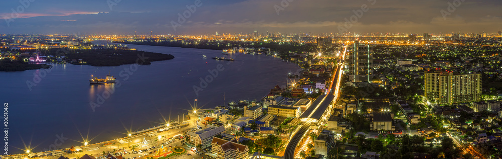 Panorama Street lights and lights from residential homes in the suburbs during sunset time, boat traffic Vehicle traffic in Samut Prakan, Thailand