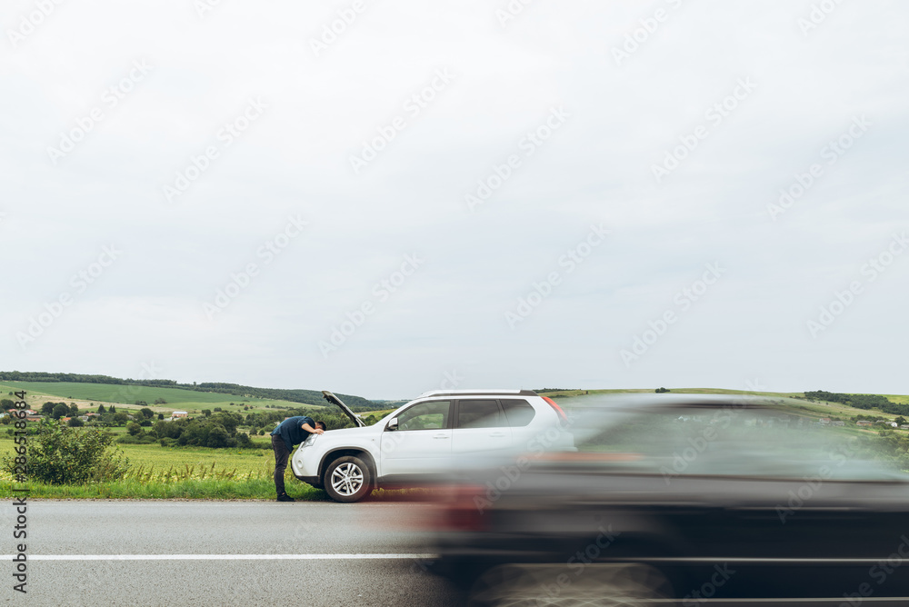 man stand near broken car with opened hood. emergency service man stand near broken car with opened hood. emergency service