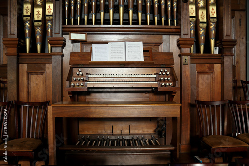 Closeup of an old pipe organ in a church.