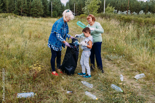 people are cleaning plastic garbage in the woods