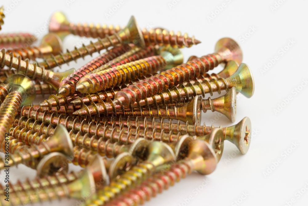 Tapping screw . Closeup yellow zinc coated screw isolate on white background. Tapping screw . Closeup yellow zinc coated screw isolate on white background.