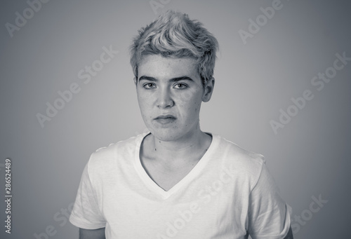 Portrait of a young teenager man with angry face looking furious.