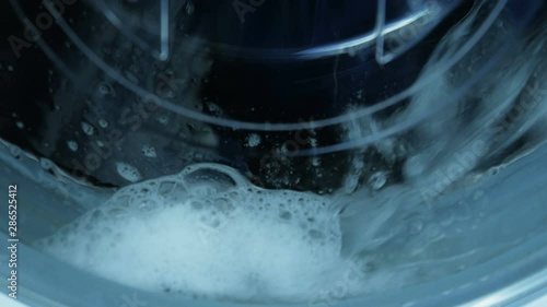 Clothes washing in the washing machine. Detergent foam.