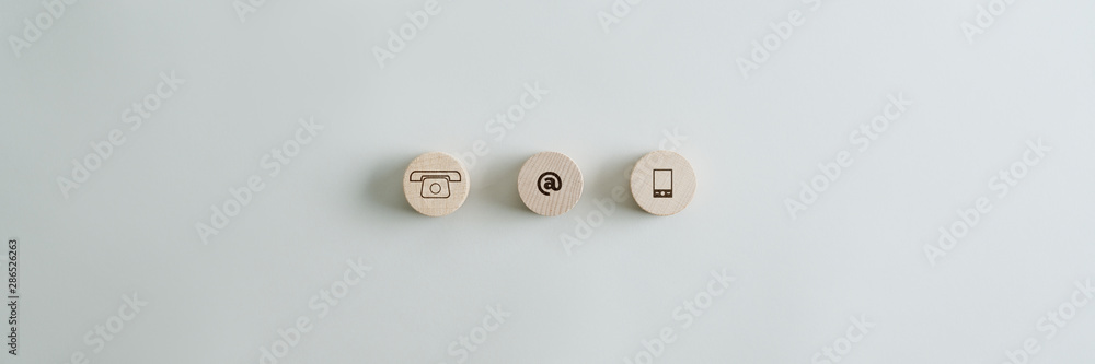 Three wooden circles with contact and communication icons Three wooden circles with contact and communication icons