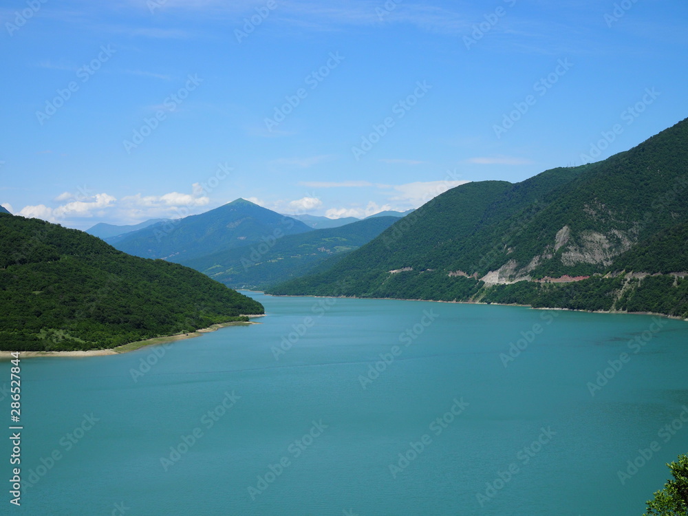 beautiful landscape overlooking a large blue lake in the mountains covered with forest beautiful landscape overlooking a large blue lake in the mountains covered with forest
