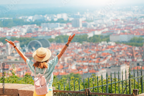 Happy woman admiring great view of the Lyon city from a view point