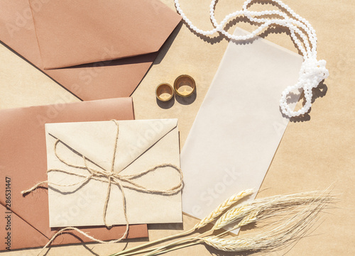Flat lay wedding invitations in envelopes with paper background