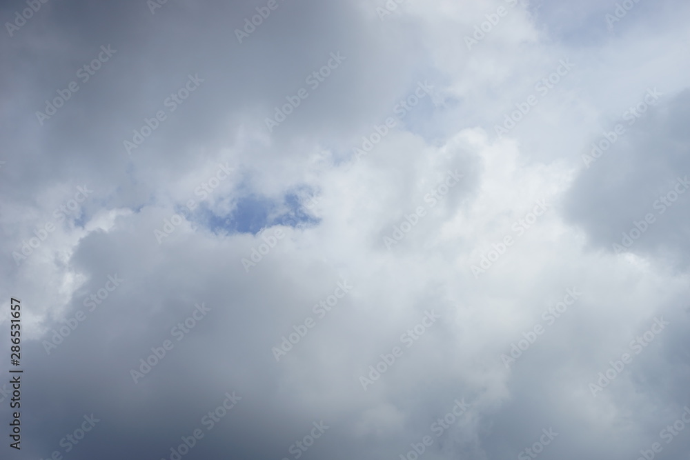 large-sized gray thunderclouds covered almost the entire blue sky