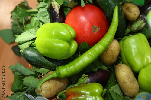 Assortment of fresh vegetables from Farmers market. Healthy food. Assorted fresh vegetables. On a black wooden background. View from above. Pepper  eggplant  cucumber .